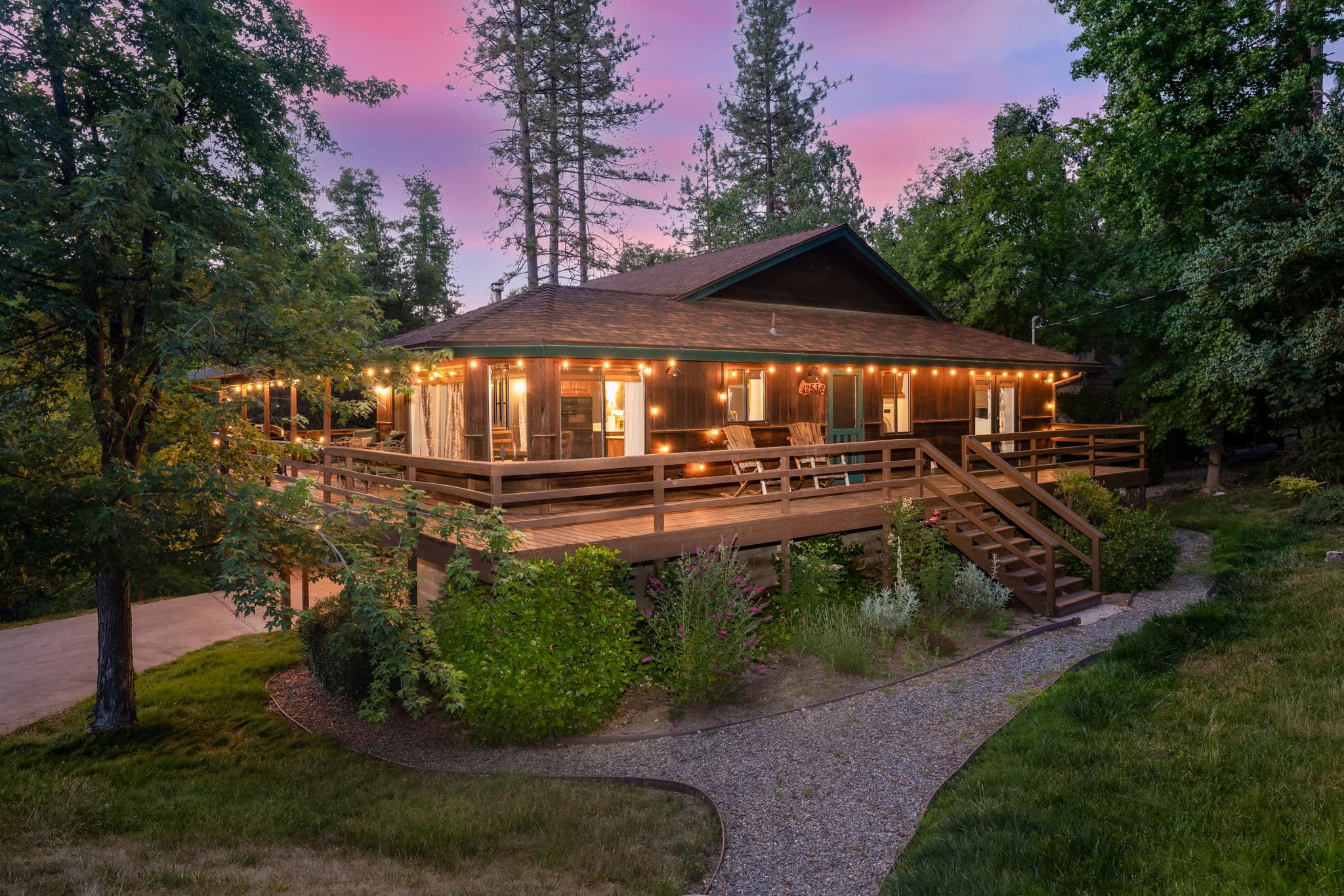 Exterior front view of Buckeye Treehouse cabin with natural wood siding and large windows — MLS listing photo
